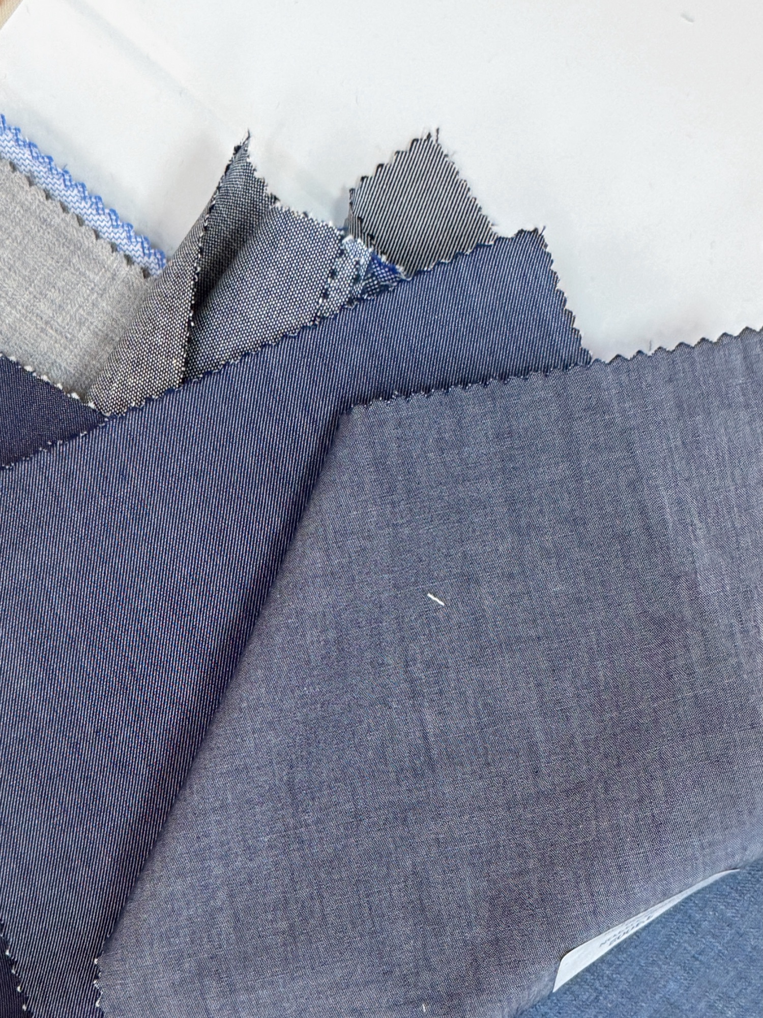Blue and grey fabric samples arranged for comparison