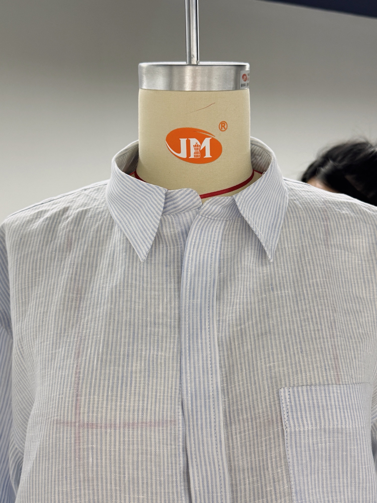 Striped shirt sample on a dress form during collar review